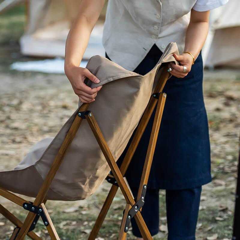 Glamping chair with sturdy canvas fabric and wooden frame.
