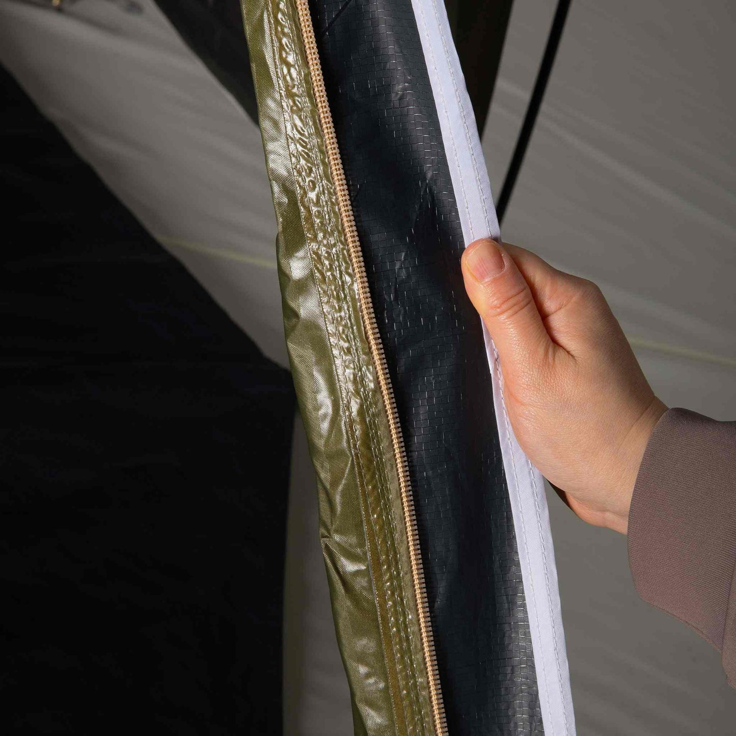 Close-up view of the Pico 2.0 Blackout tent's waterproof seam and zipper.