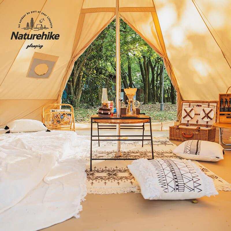 Spacious glamping tipi tent interior with luxurious decor and Naturehike branding in forest setting.