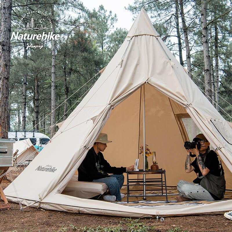 Spacious glamping tipi tent by Naturehike in a forest setting, made of durable cotton with 6000mm water resistance, ideal for 4-5 people.